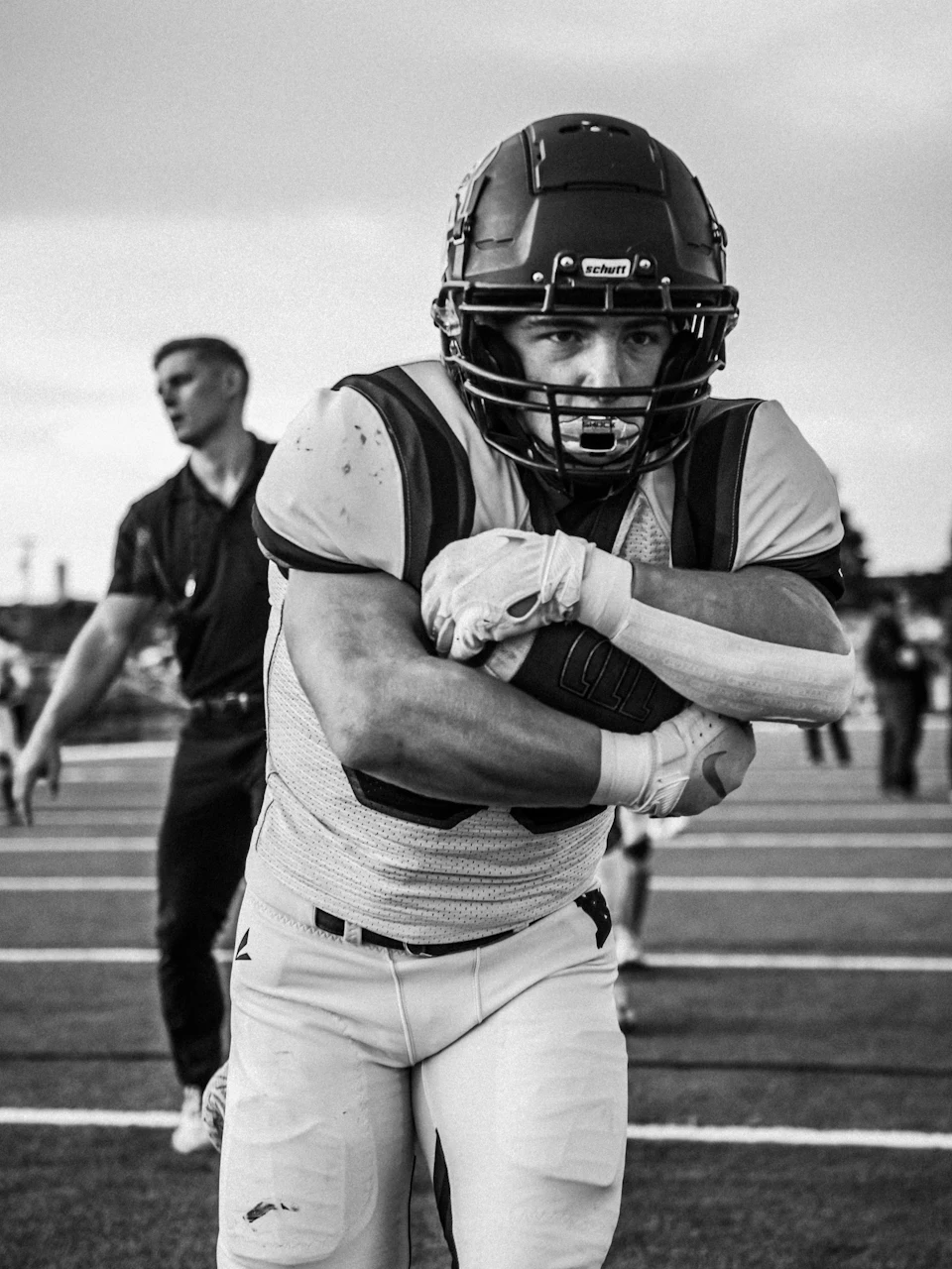 A football player charging forward with the ball