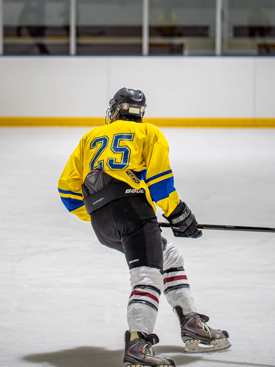 A hockey player skating up the ice